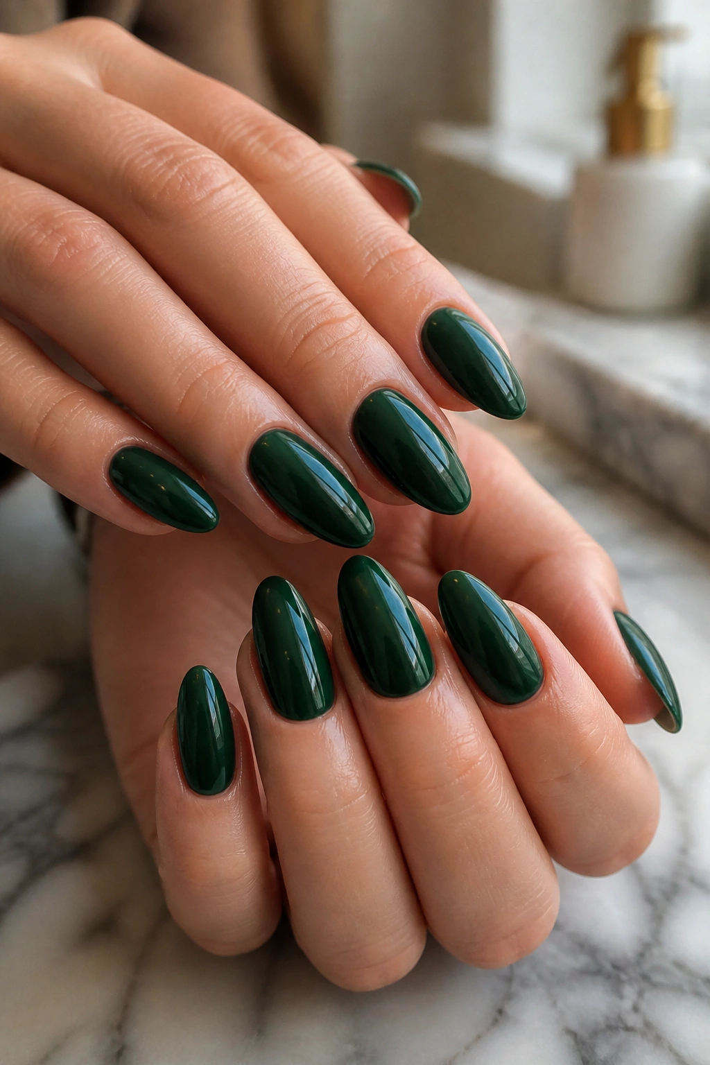 Close-up of deep emerald glossy almond nails on a real hand
