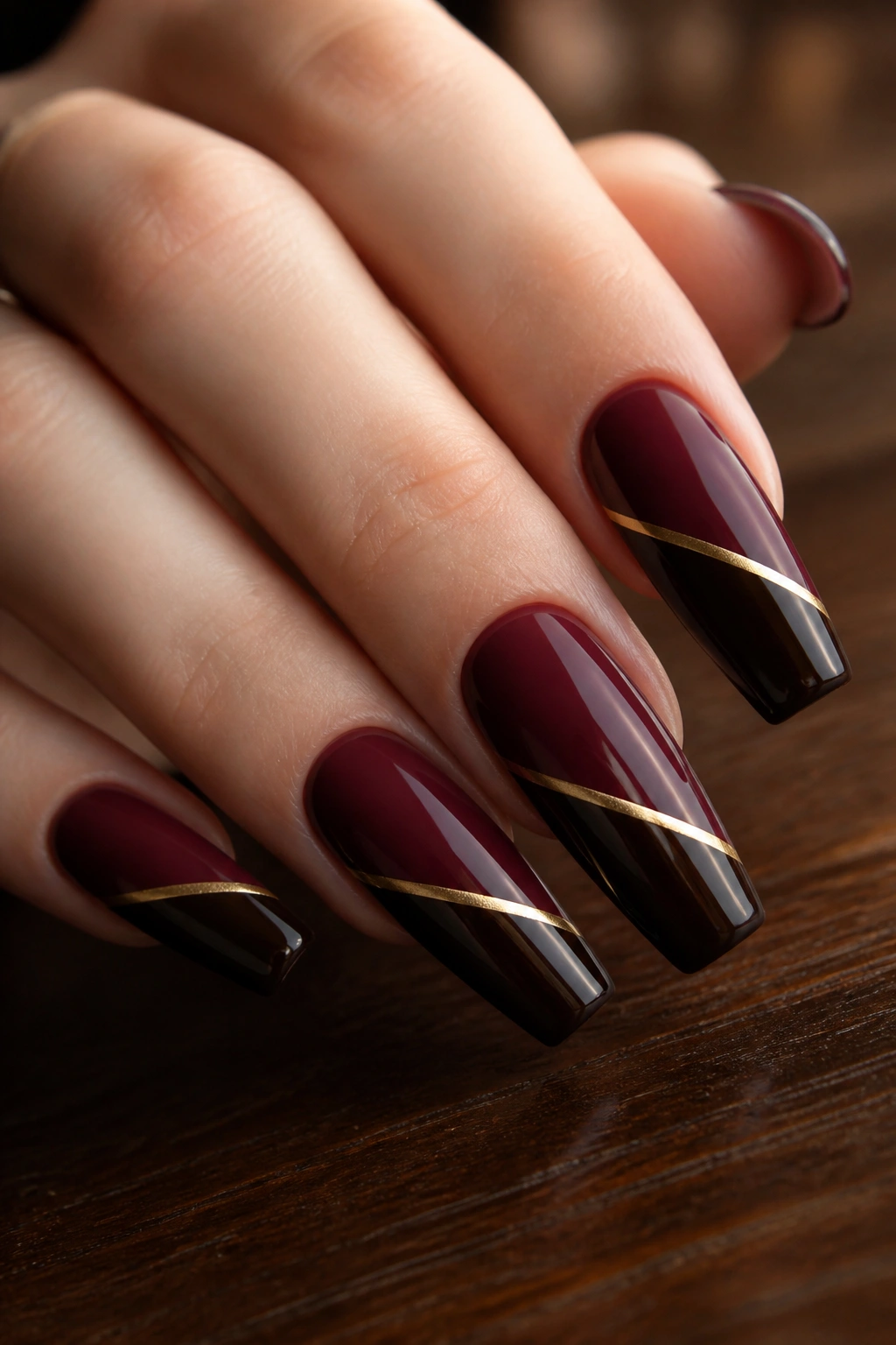 Color-block burgundy and espresso coffin nails with gold divider