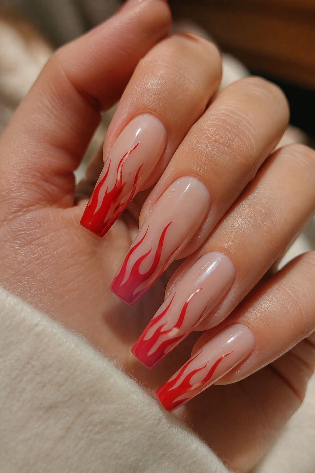 Nude-based coffin nails with cherry red flame tips