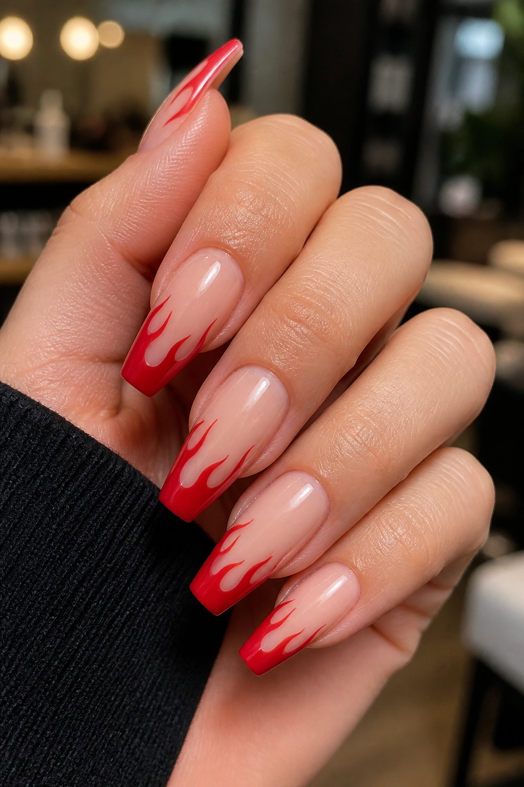 Close-up of flame-shaped red tips along the coffin edge on a real hand