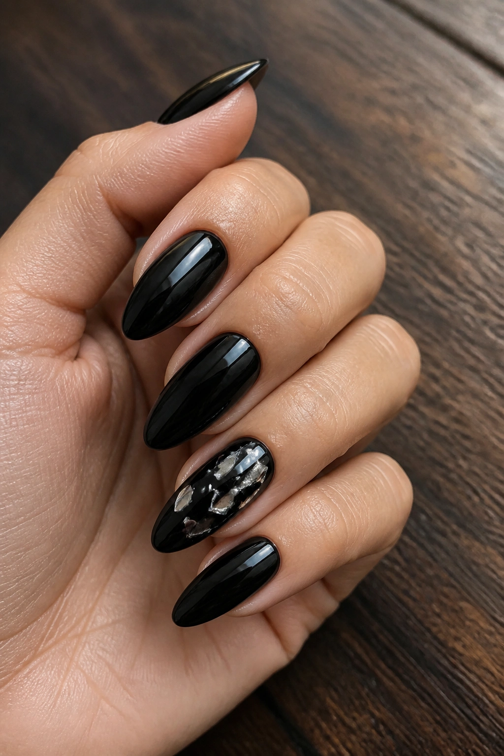 Almond nails with shattered glass foil on black base