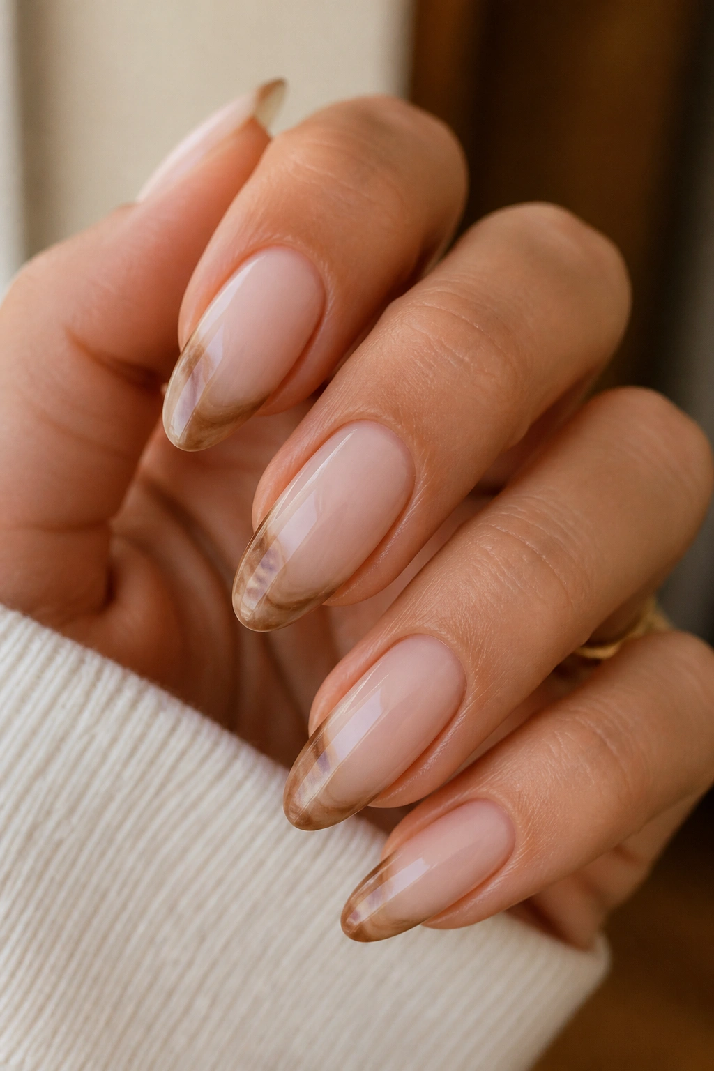 Almond nails with cappuccino swirl French tips on a nude base