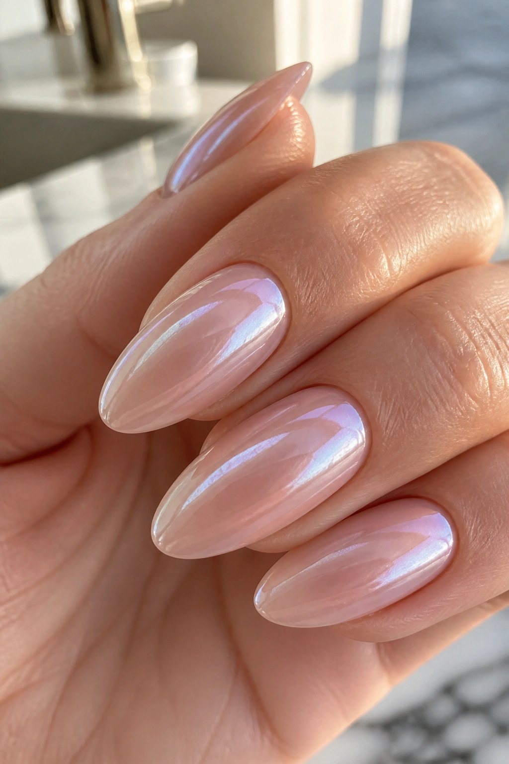 Almond nails with ghost chrome pearlescent finish on nude base