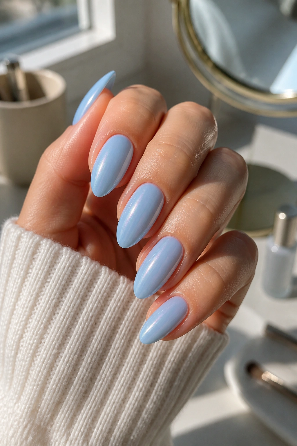 Almond nails with glazed baby blue finish on a real hand