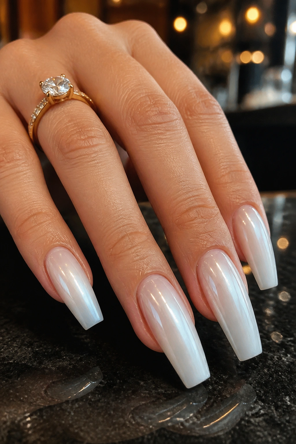 Close-up of glazed chrome white ombre coffin nails showing pearlescent reflections.