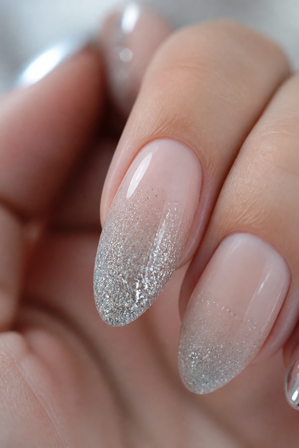 Almond nail with silver glitter fade from cuticle to tip