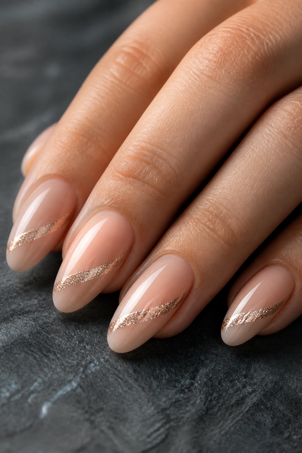 Close-up of almond nails with sideways glitter swoop on a real hand