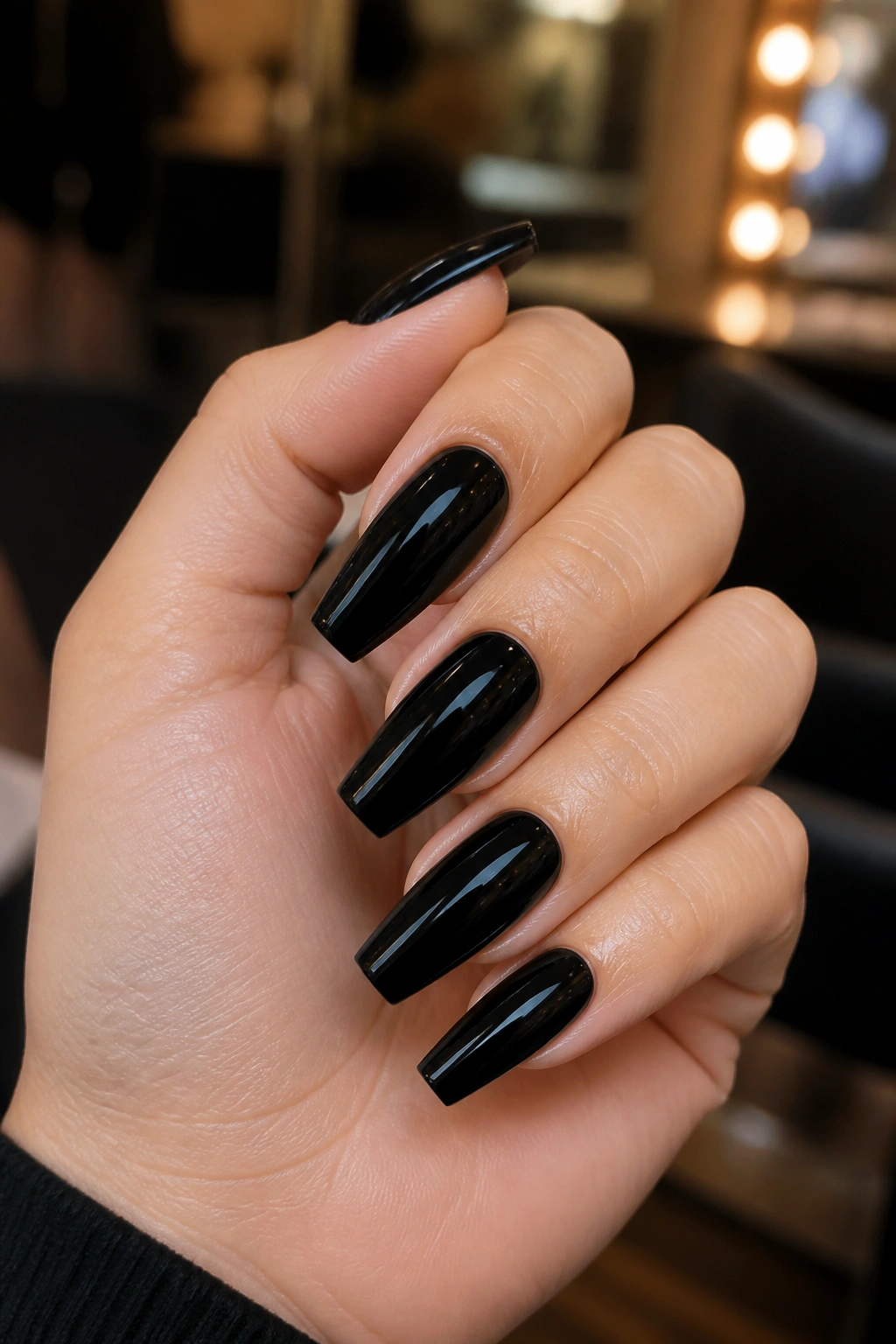 Close-up of glossy black coffin nails on real hand