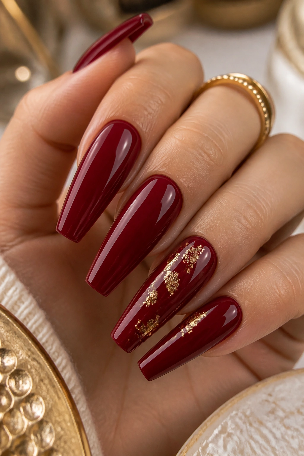 Coffin nails with cherry red base and subtle gold foil details