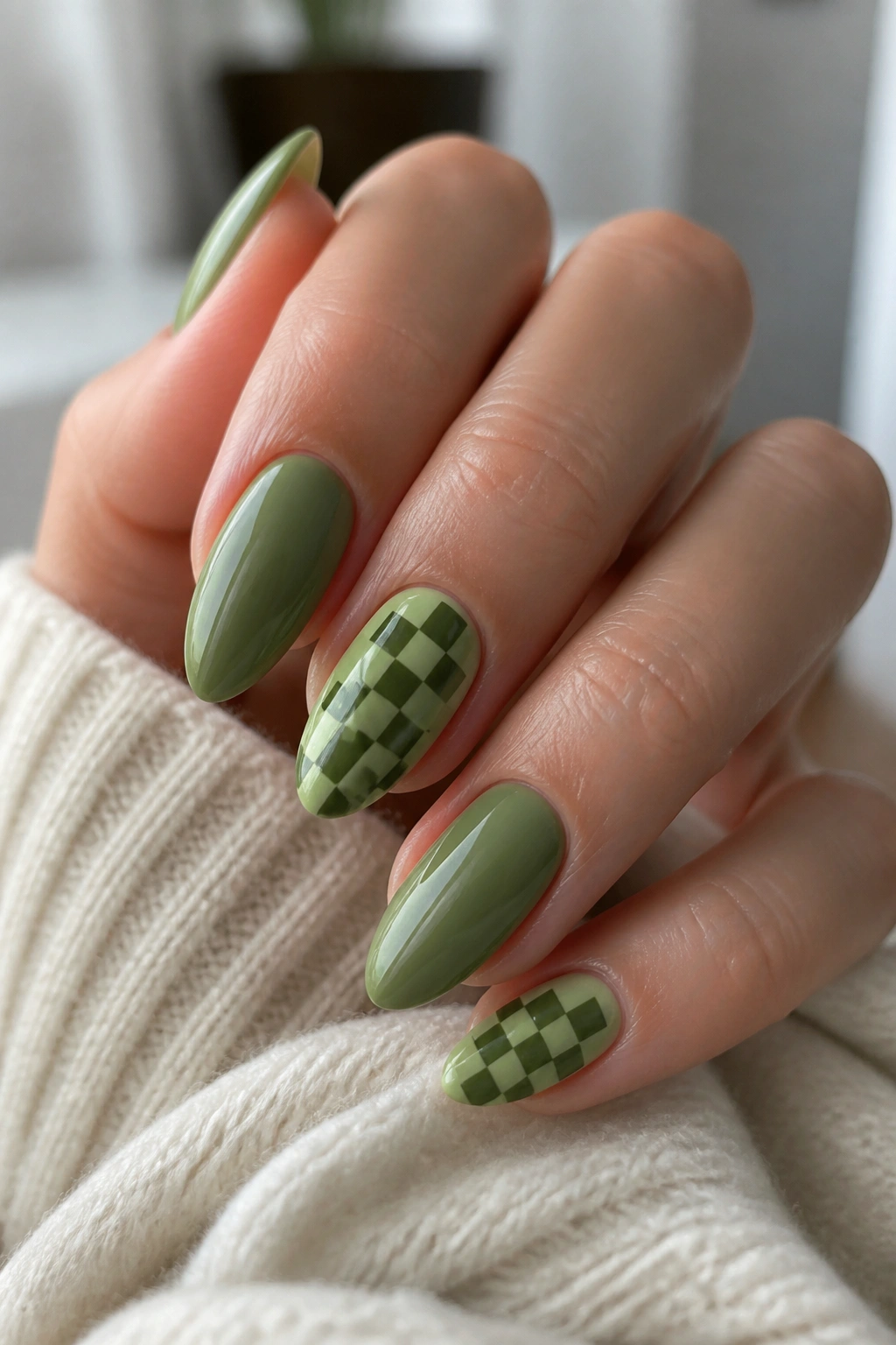 Almond nails with small green checkered accents on accent nails