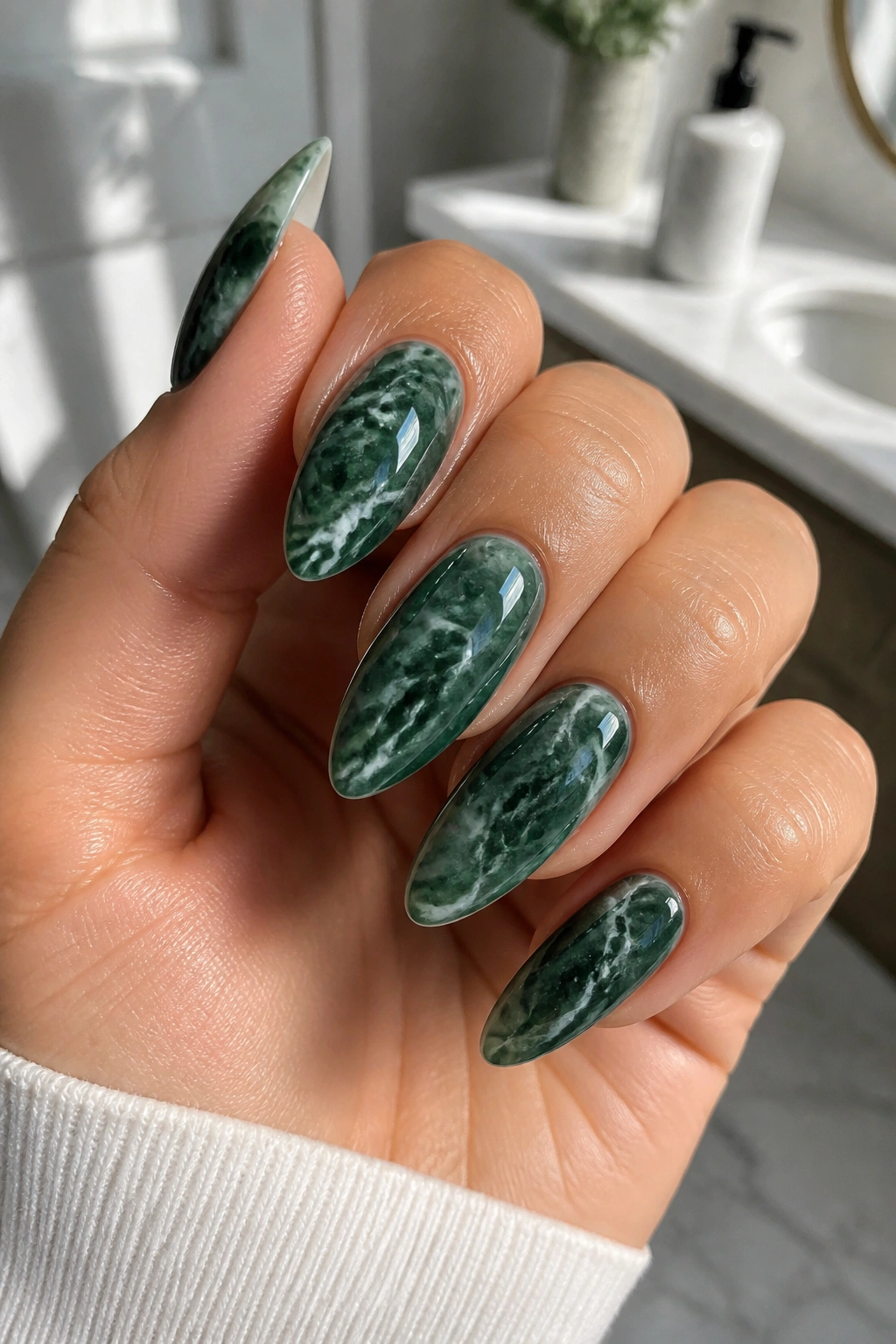 Green marble swirl almond nails on a real hand