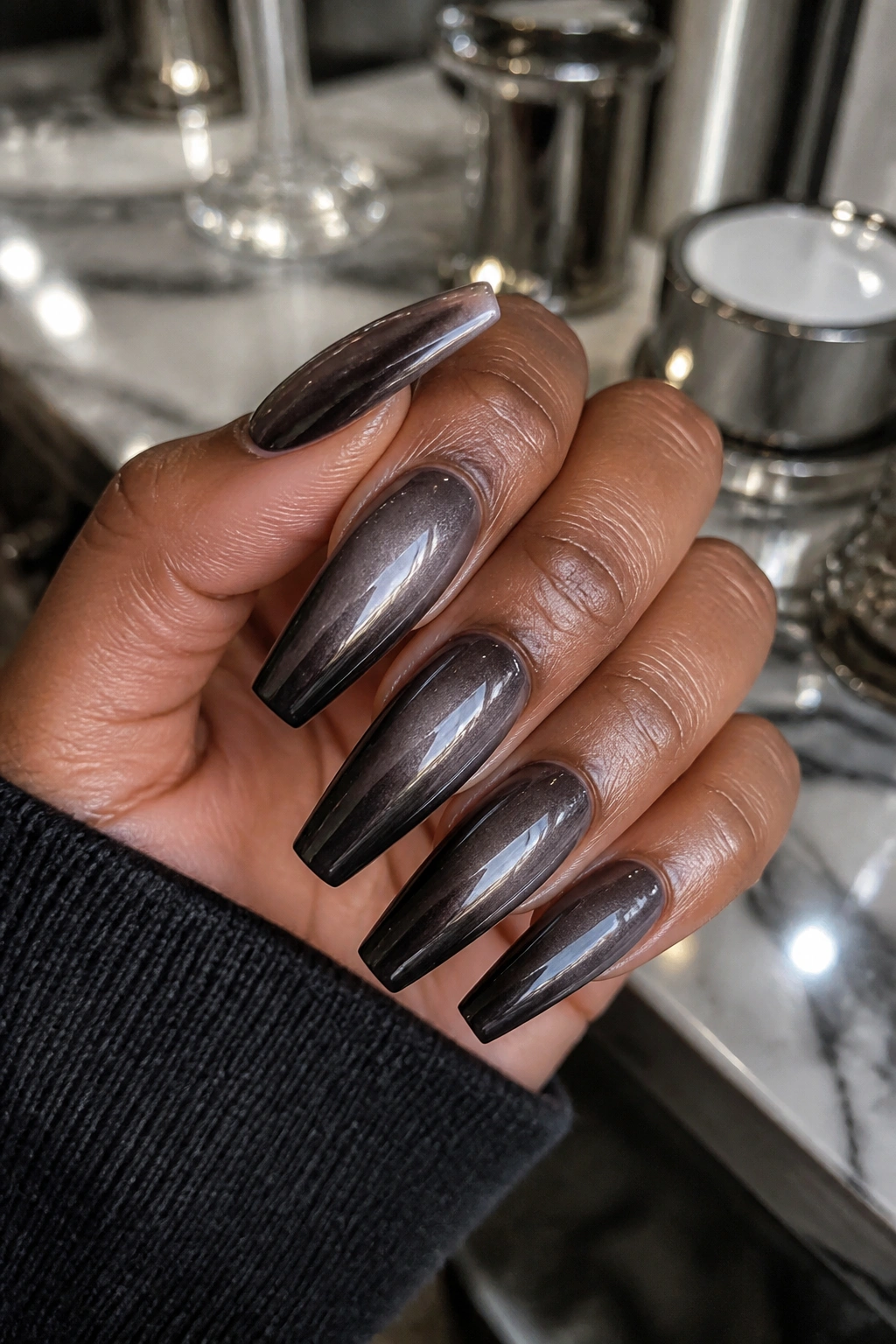 Close-up of coffin nails with black fade and gunmetal chrome veil.