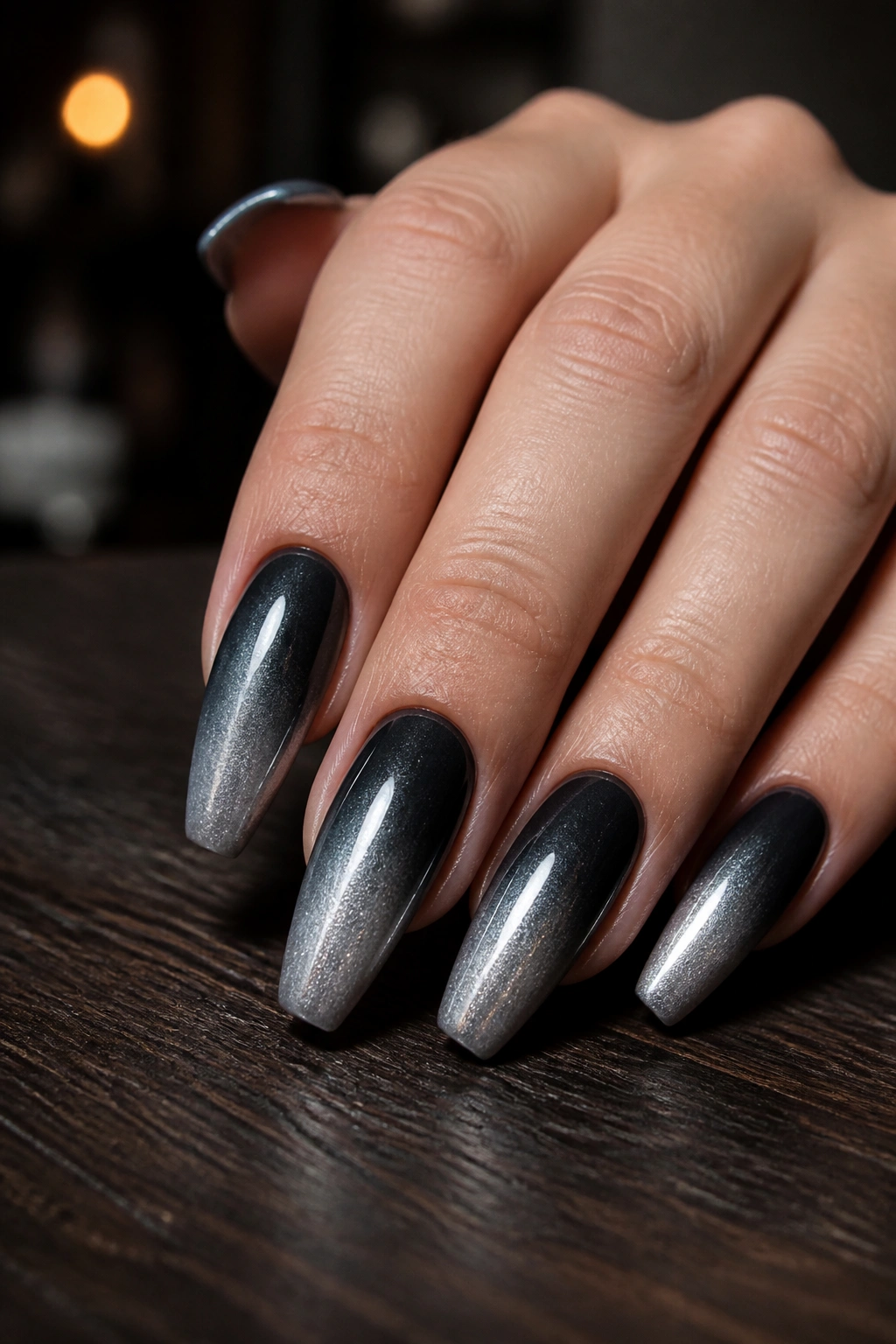 Close-up of gunmetal ombre coffin nails on real hand