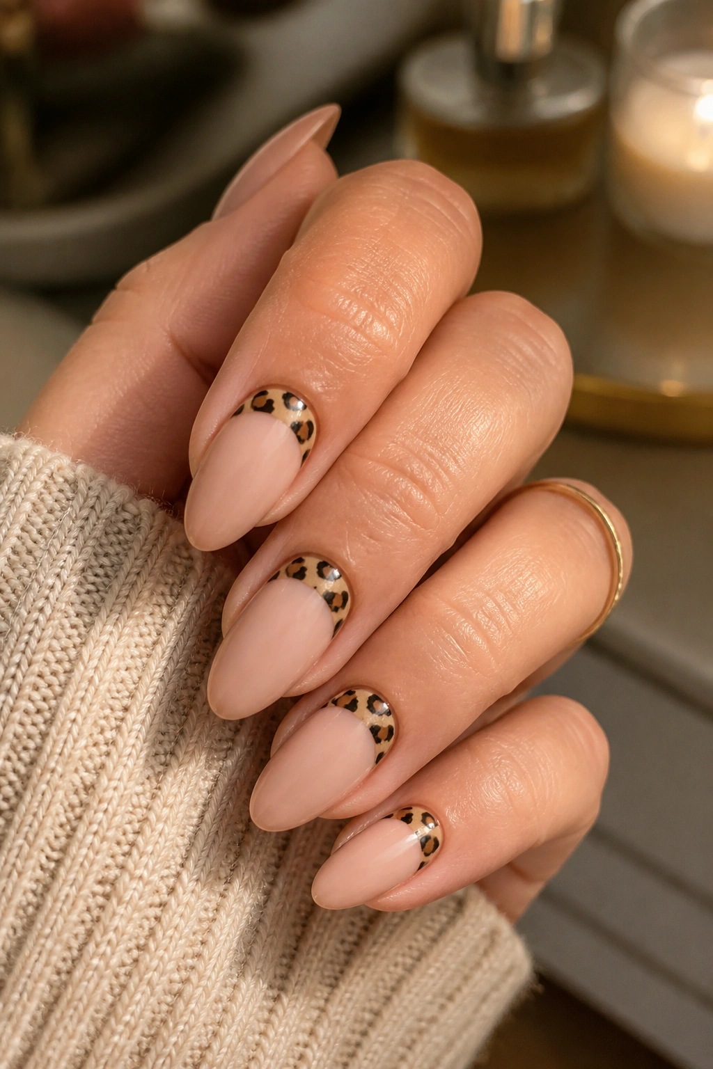Almond nails with cheetah half-moon accents near the cuticle