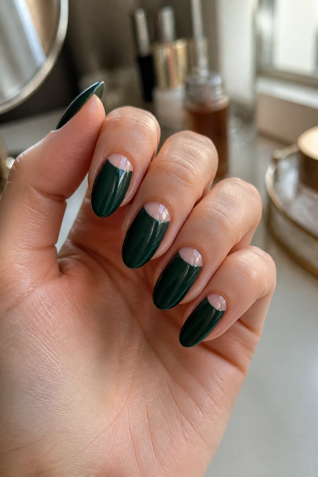 Half-moon dark green almond nails on a real hand