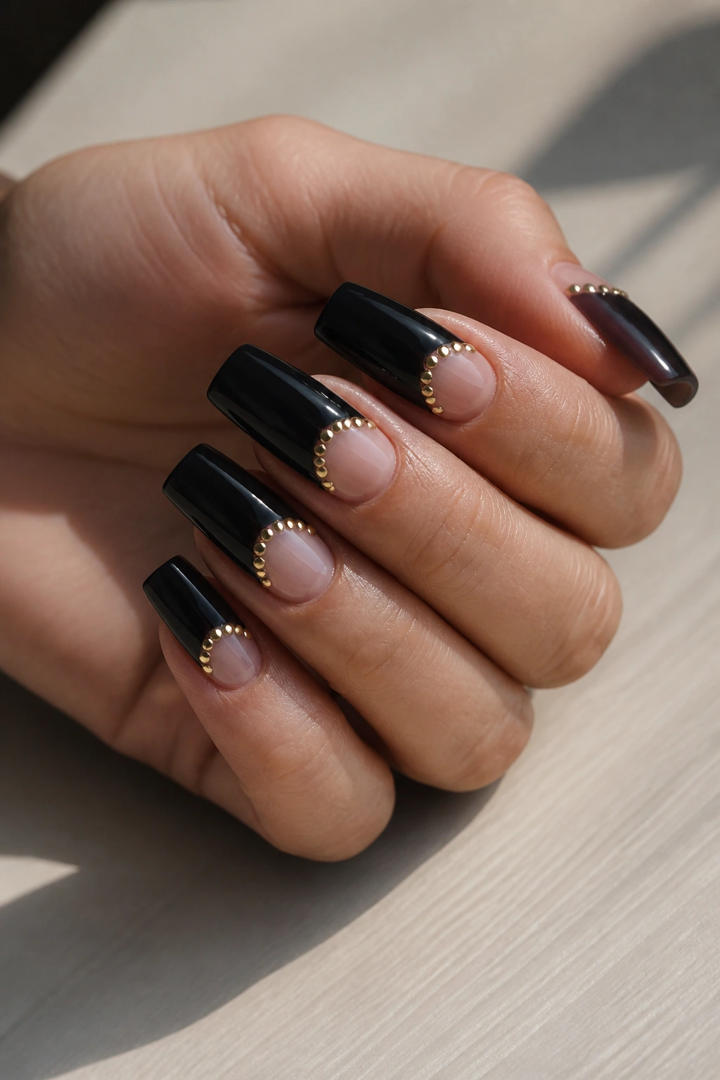 Half-moon black coffin nails with small gold studs