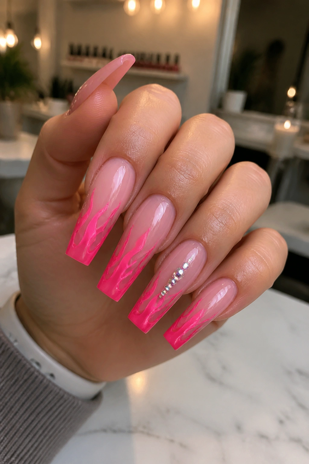 Close-up of hot pink flame tips on coffin nails