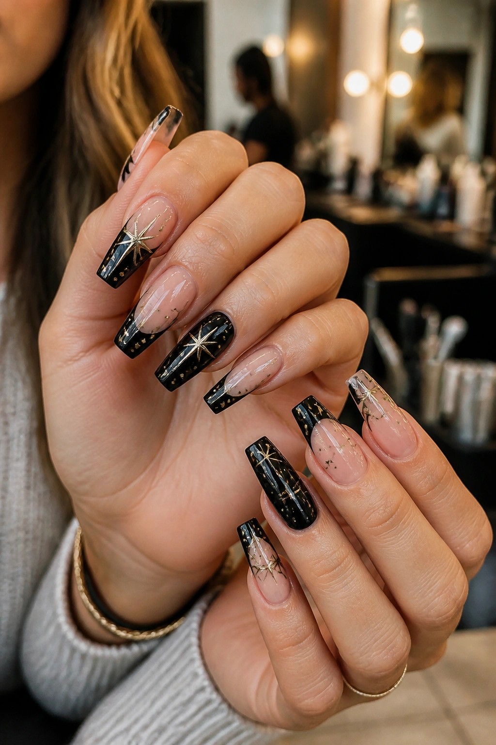 Hands with star coffin nails shown in a real-person portrait in a salon setting