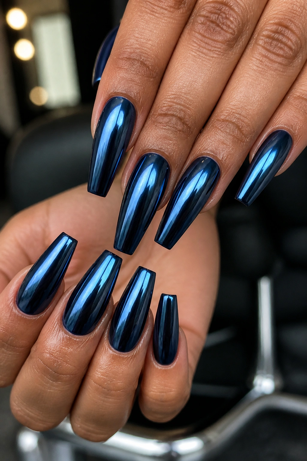 Ink blue chrome coffin nails on real hands with mirror shine