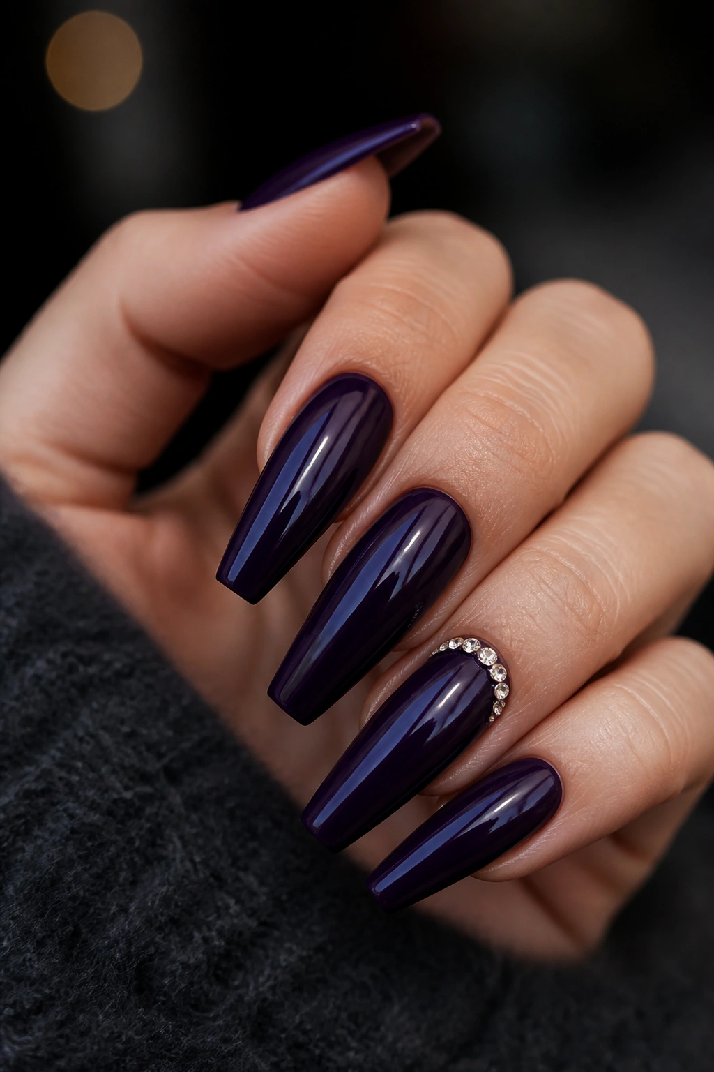 Close-up of ink purple coffin nails with tiny crystal cuticles