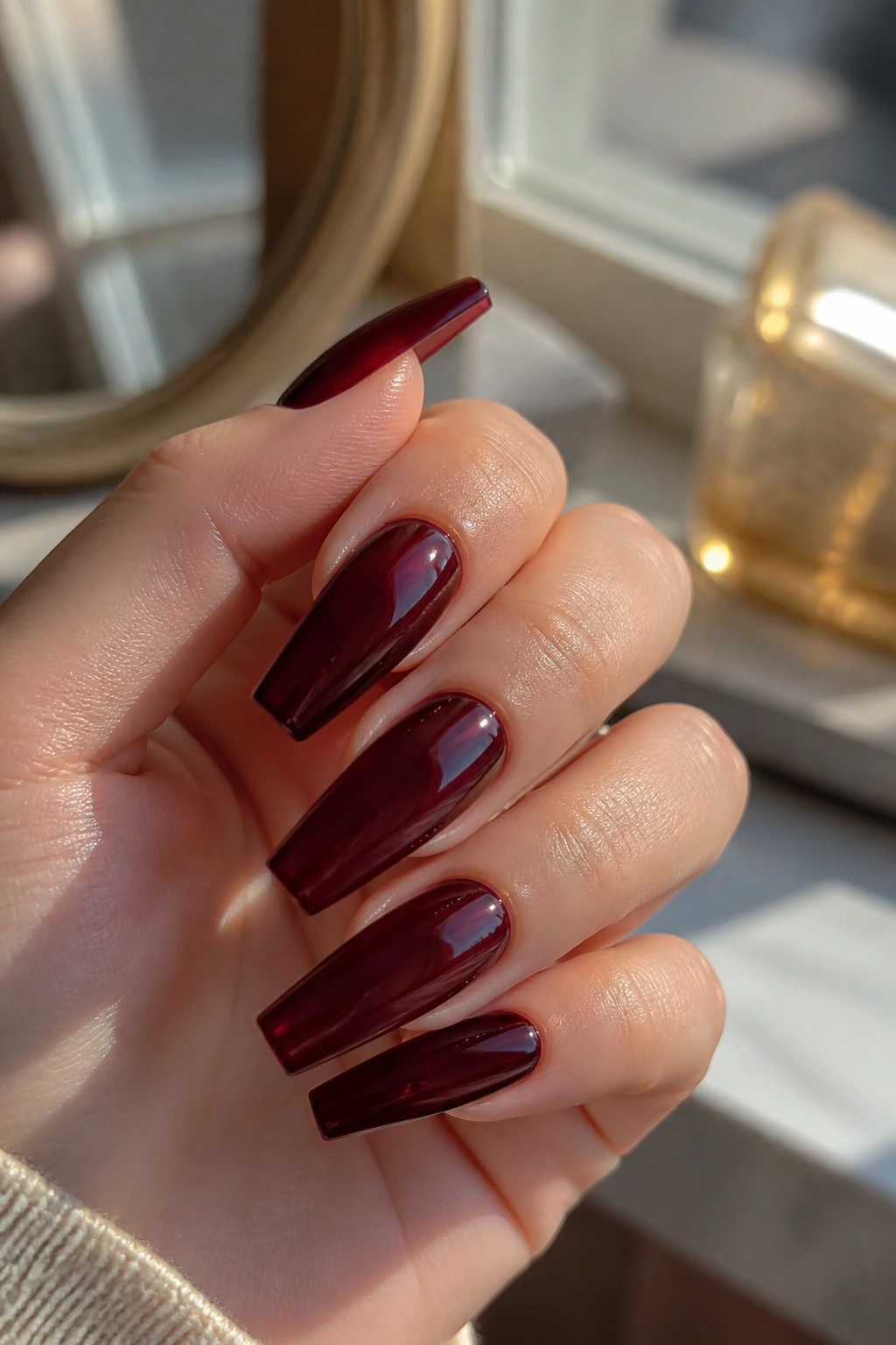Hand with black cherry jelly burgundy coffin nails translucent depth