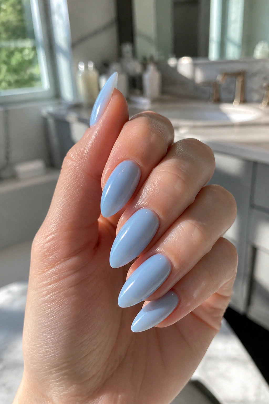 Close-up of almond nails with translucent jelly blue finish