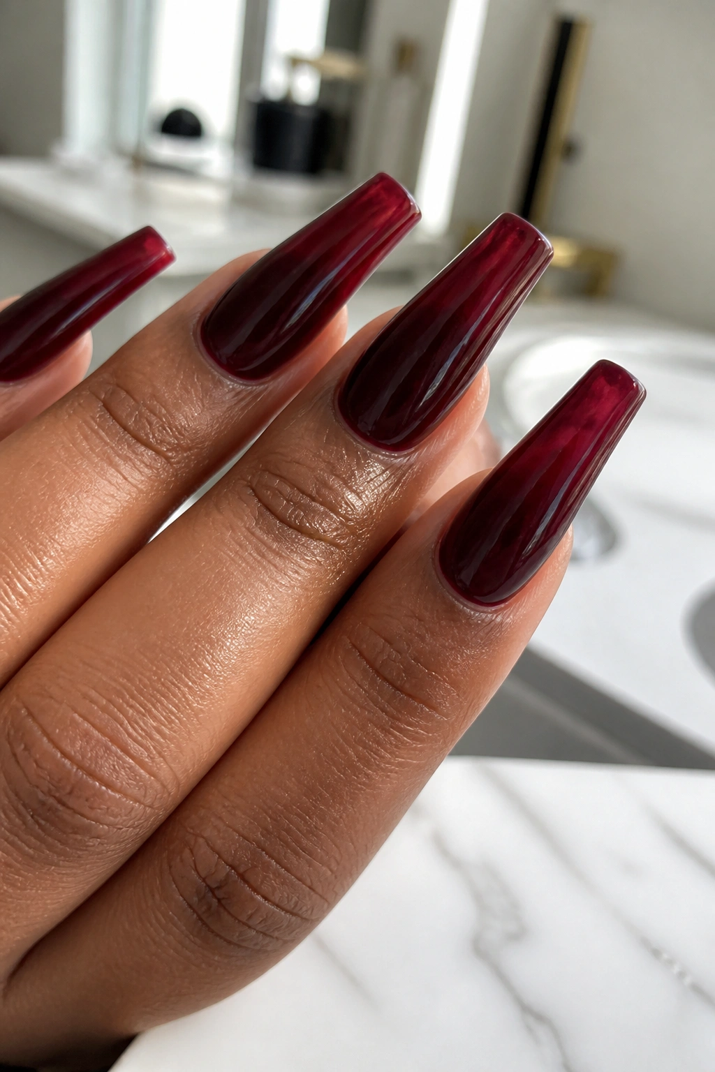 Close-up of black cherry jelly maroon coffin nails showing translucent tips