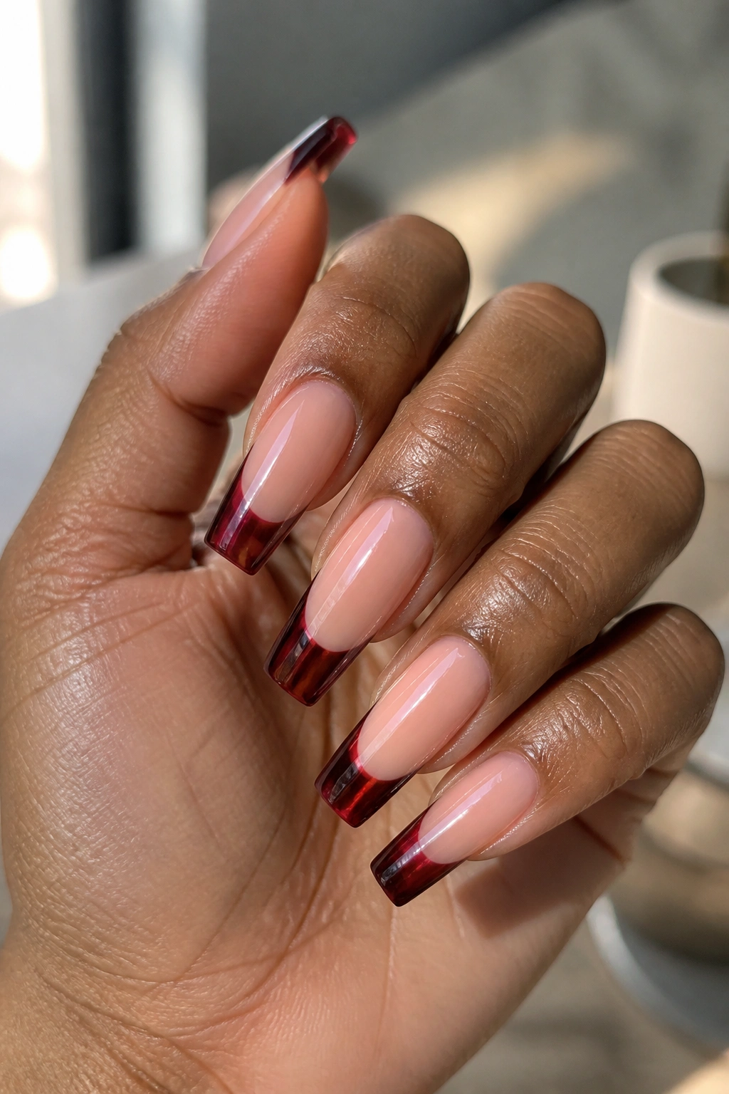 Close-up of jelly sangria tips with a glassy finish on coffin nails.