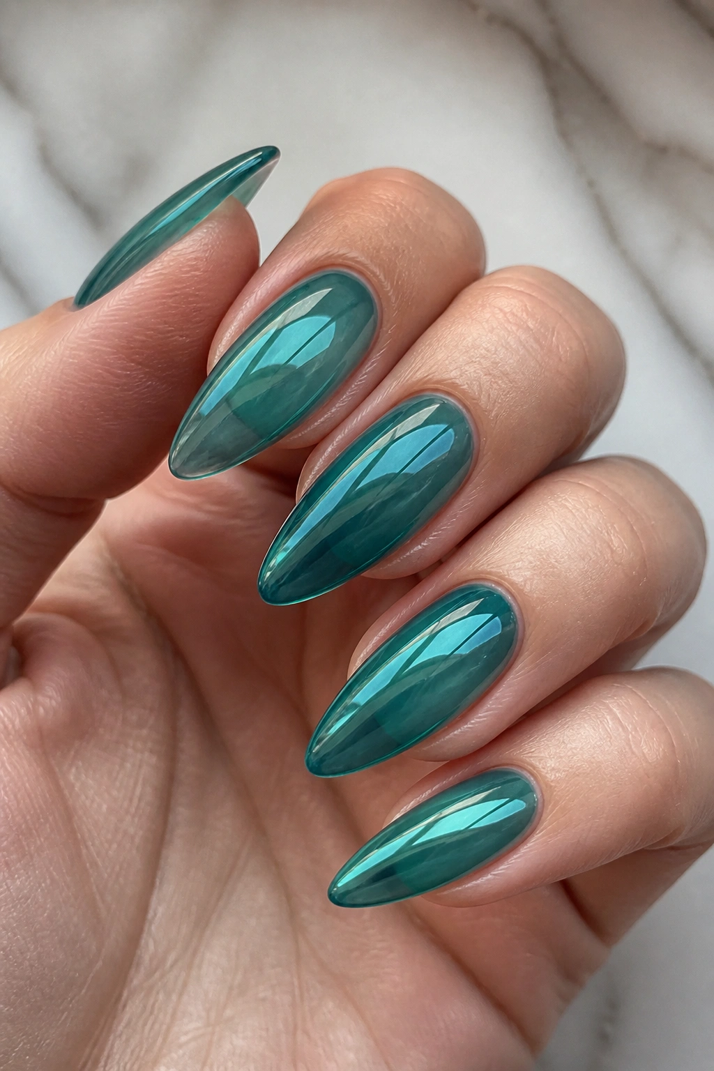 Translucent jelly teal almond nails on real hand