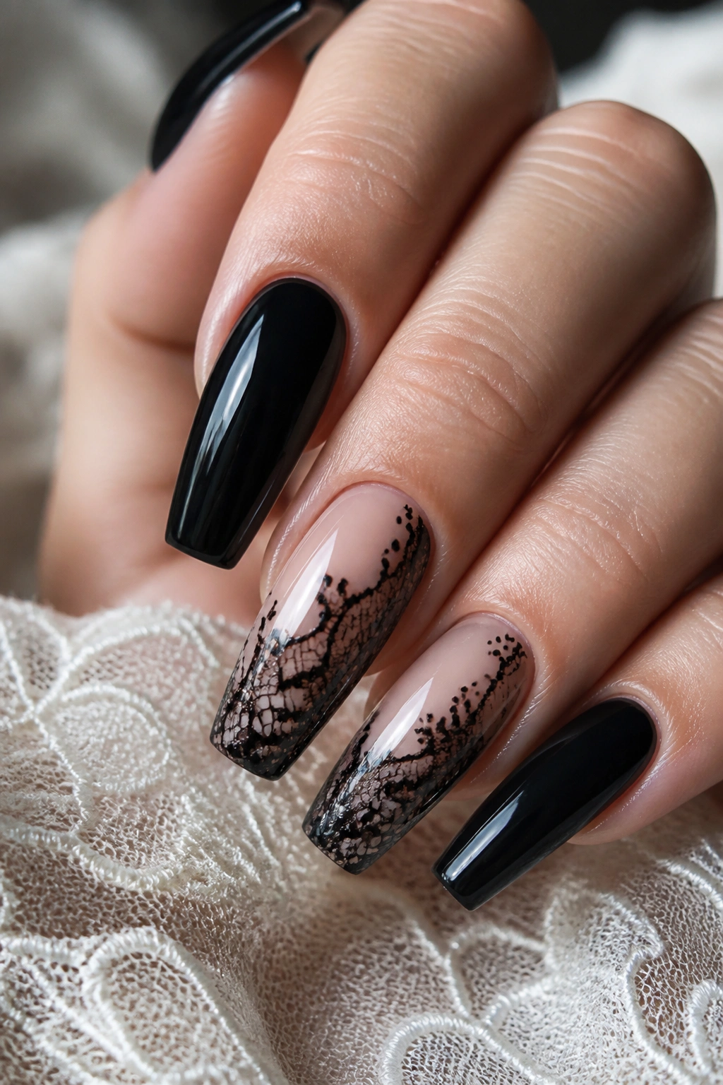 Close-up of black lace detail on coffin nails with sheer base on a real hand.