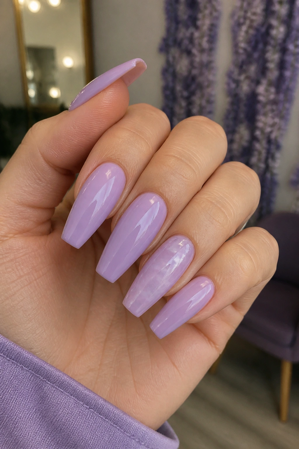 Close-up of a lavender nail set in a calm salon background