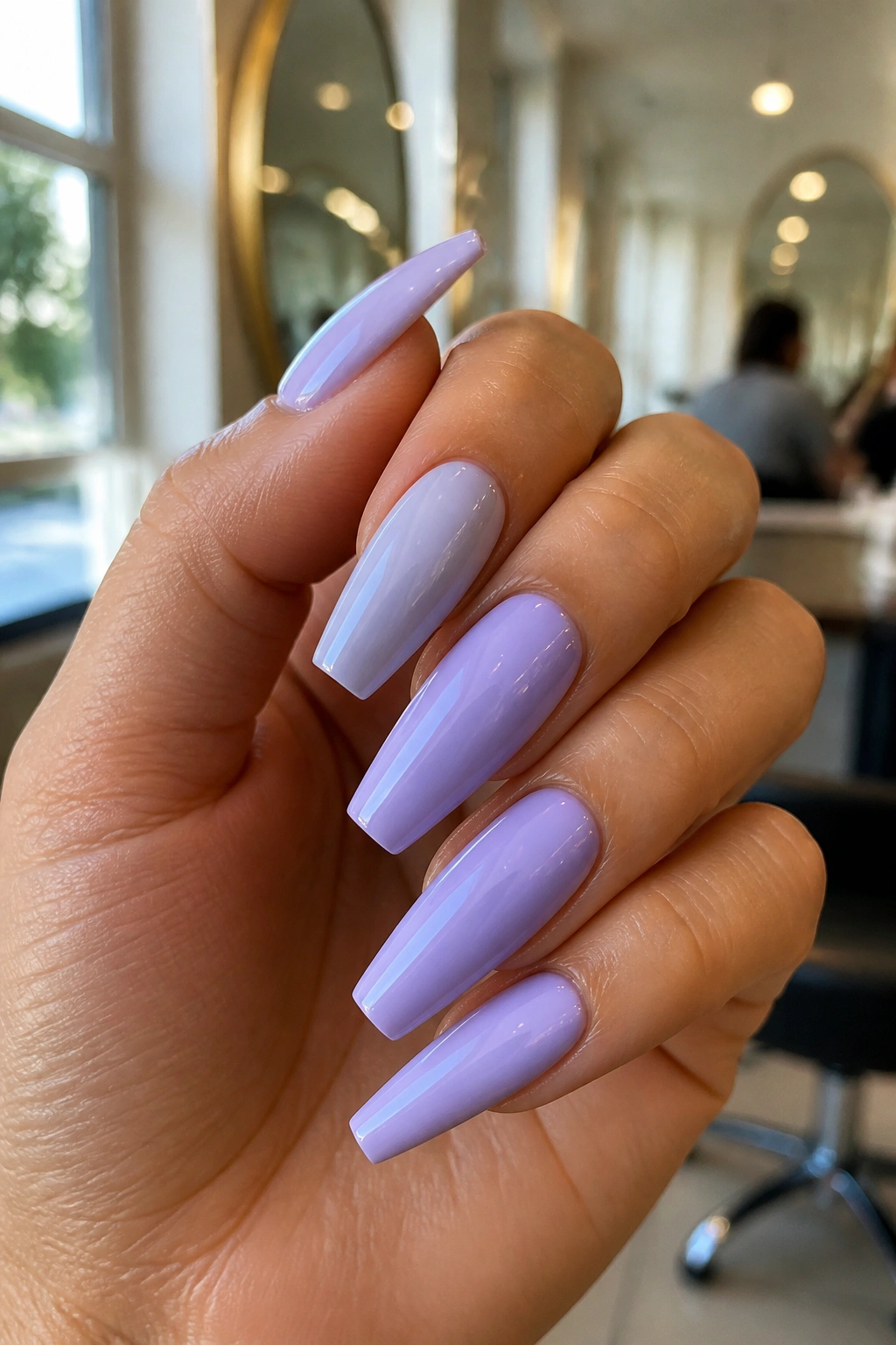 Close-up of lavender nails showing shade variation on a real hand