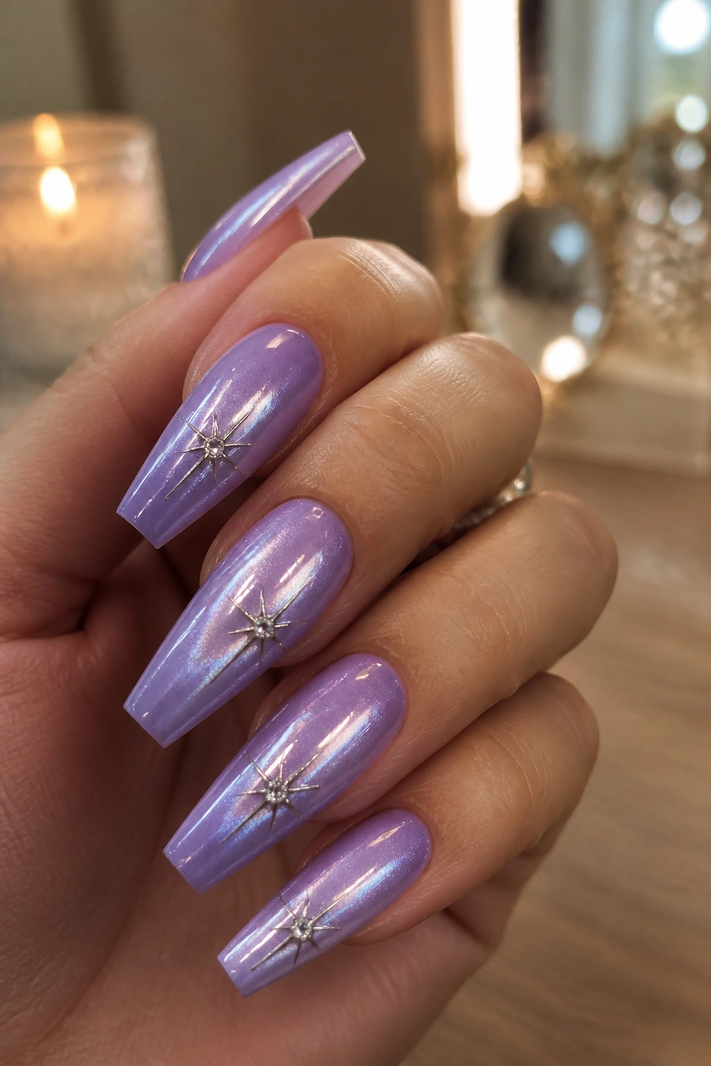Lilac cat-eye nails with crystal centers on real hand