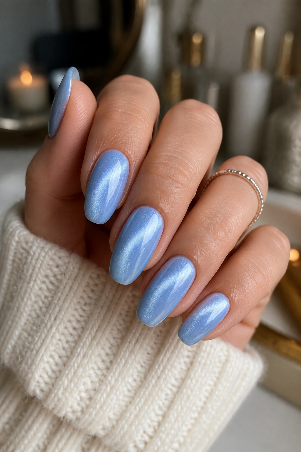 Almond nails with magnetic cat-eye shine on pale blue base