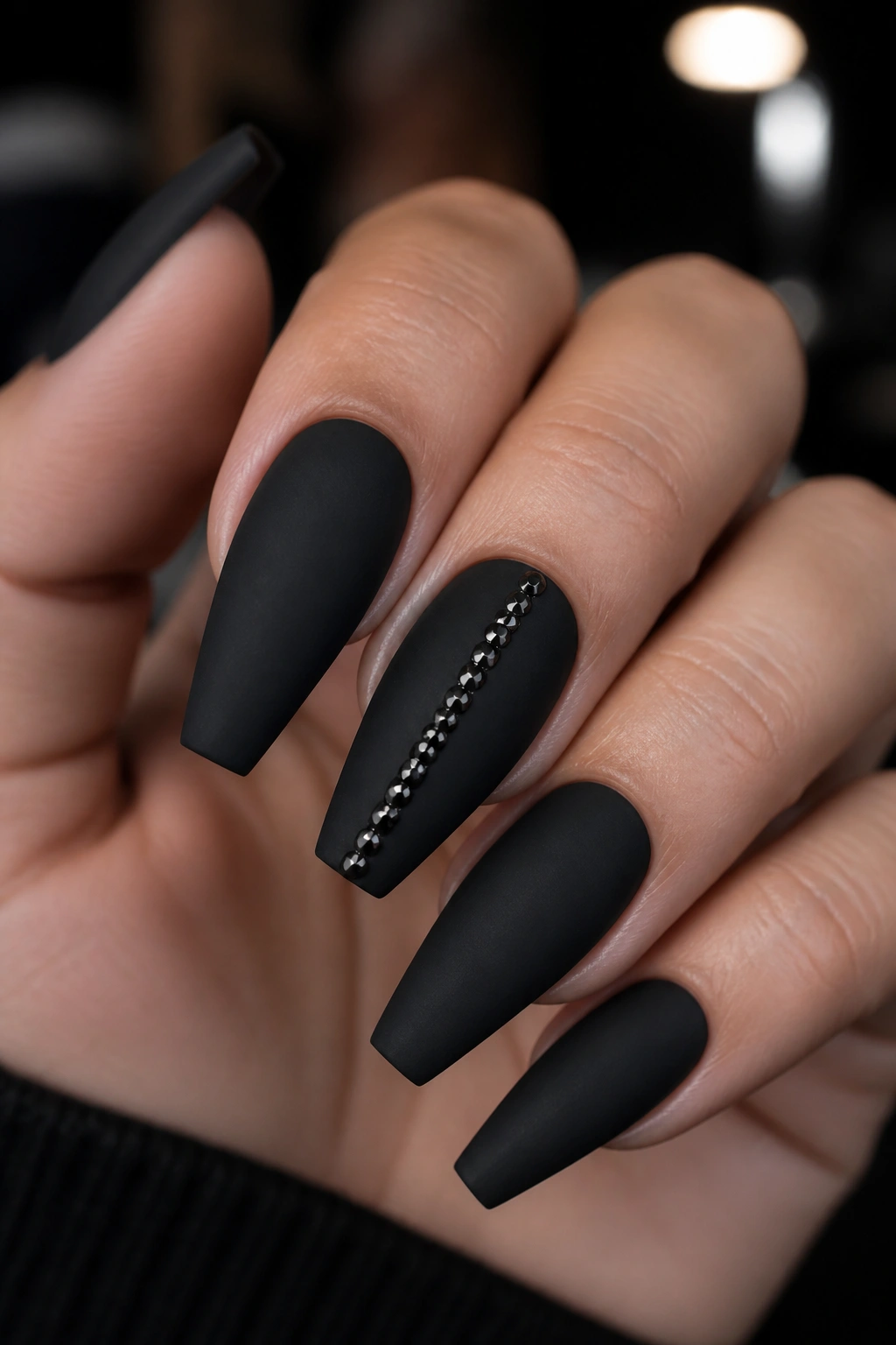 Matte black coffin nails with a vertical micro stud line on the center nail