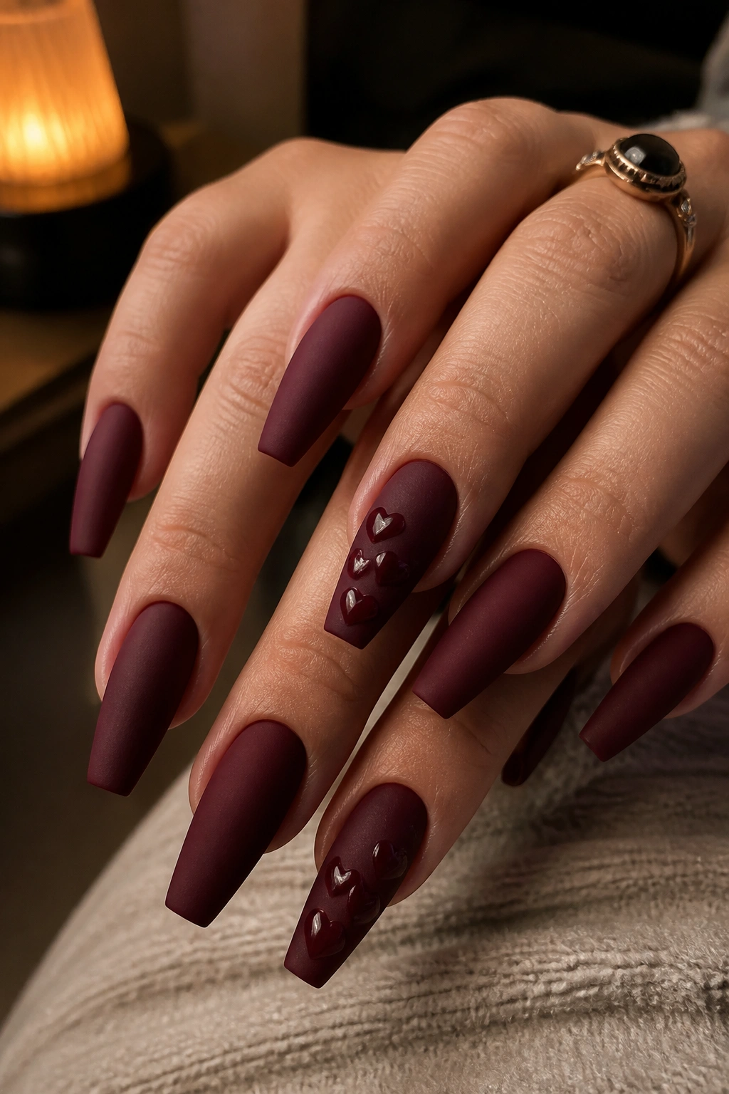 Matte burgundy coffin nails with glossy raised hearts