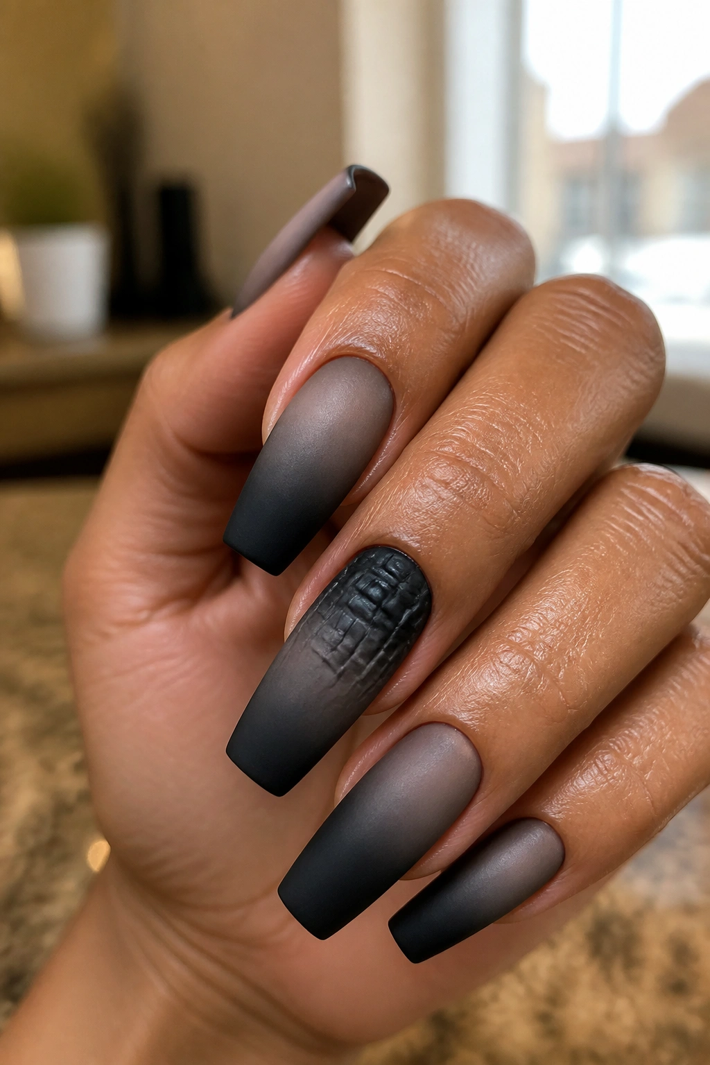 Close-up of matte croc-accented smoky fade coffin nails on real hands