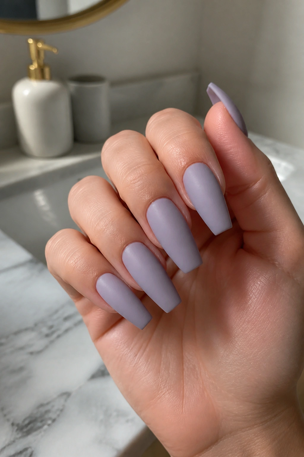 Close-up of matte dusty lilac coffin nails with crisp sidewalls on a real hand