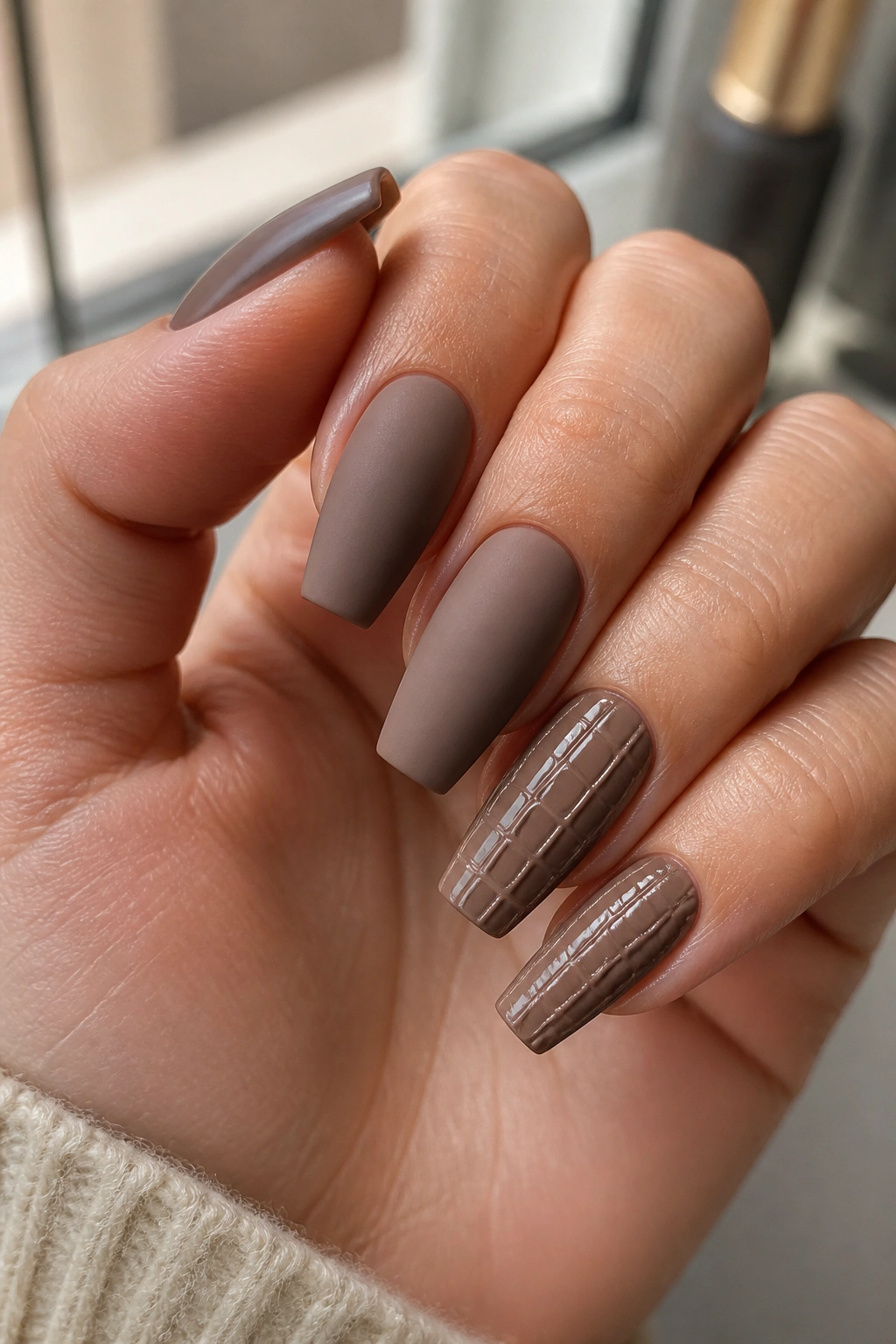 Close-up of matte mocha coffin nails with glossy croc texture on accent nails