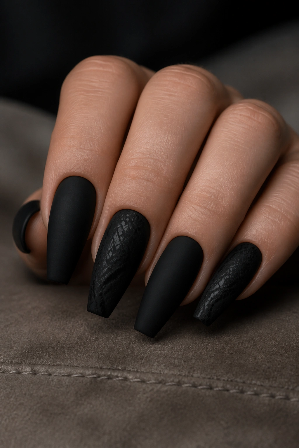 Matte black coffin nails with subtle black-on-black snake print accent nails