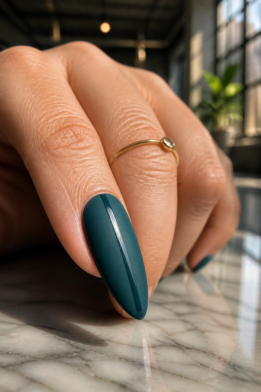 Almond nail with matte teal and a single glossy stripe