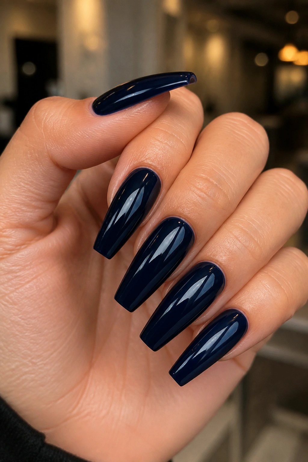 Close-up of coffin nails in glossy midnight navy