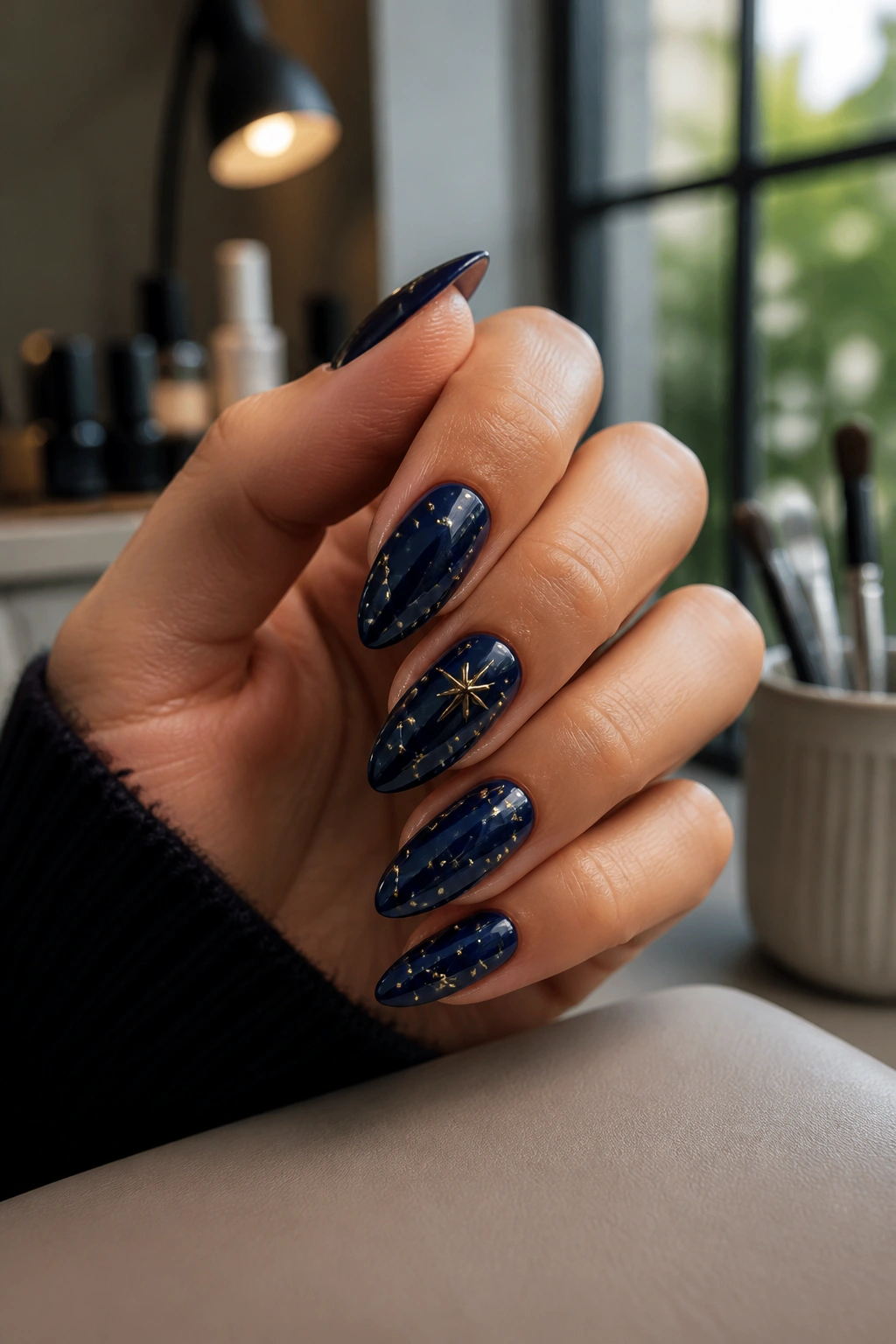 Close-up of Midnight Star Map Nails on a real hand with navy almond nails and raised star constellation details