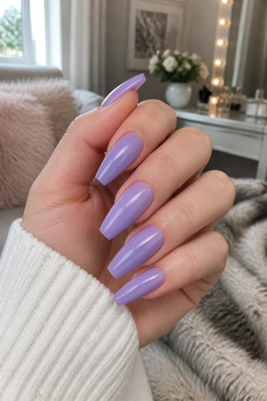 Close-up of milky lavender purple coffin nails on a real hand, medium length.