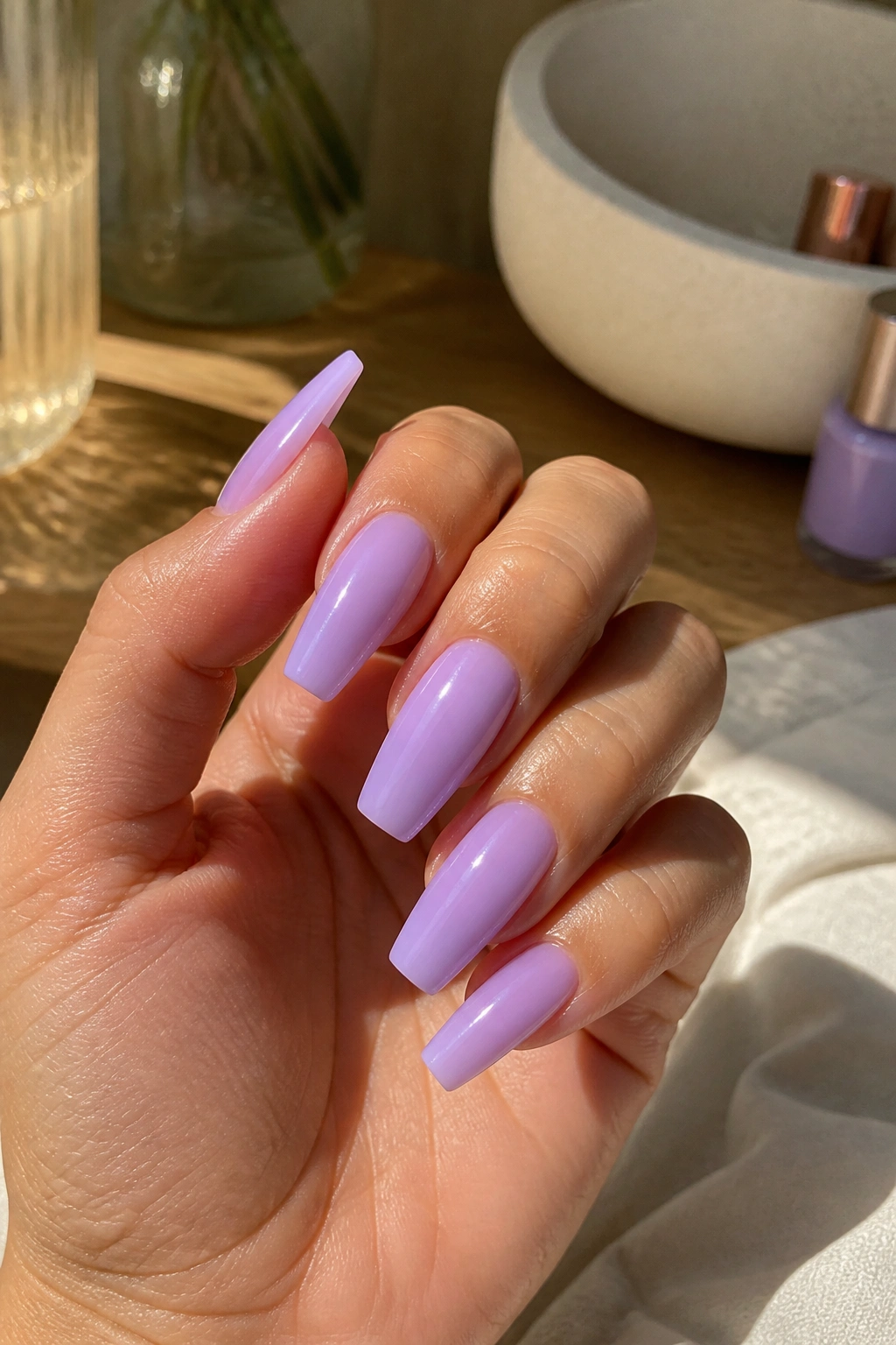 Close-up of milky lavender gloss nails on a real hand