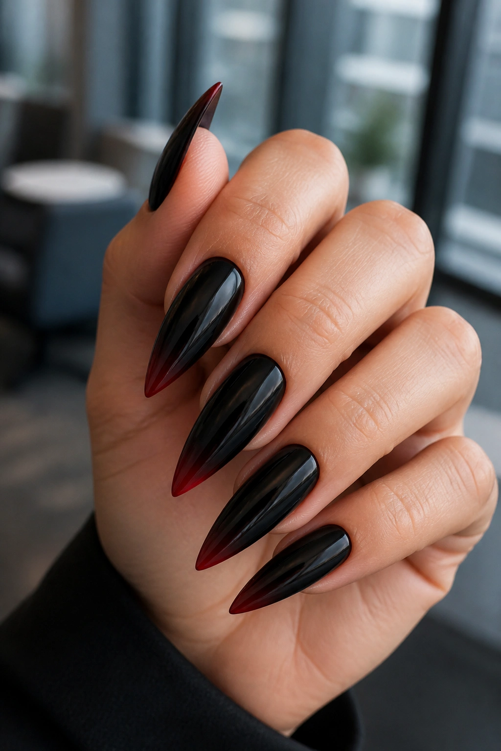 Close-up of hand with minimalist red-line ombre on stiletto nails.