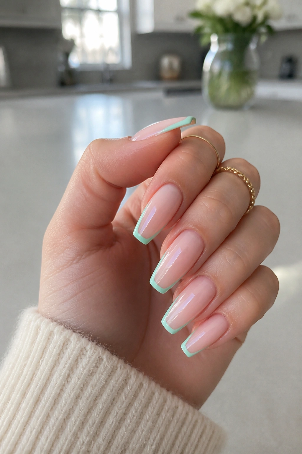 Close-up of real hand with mint-outline coffin nails