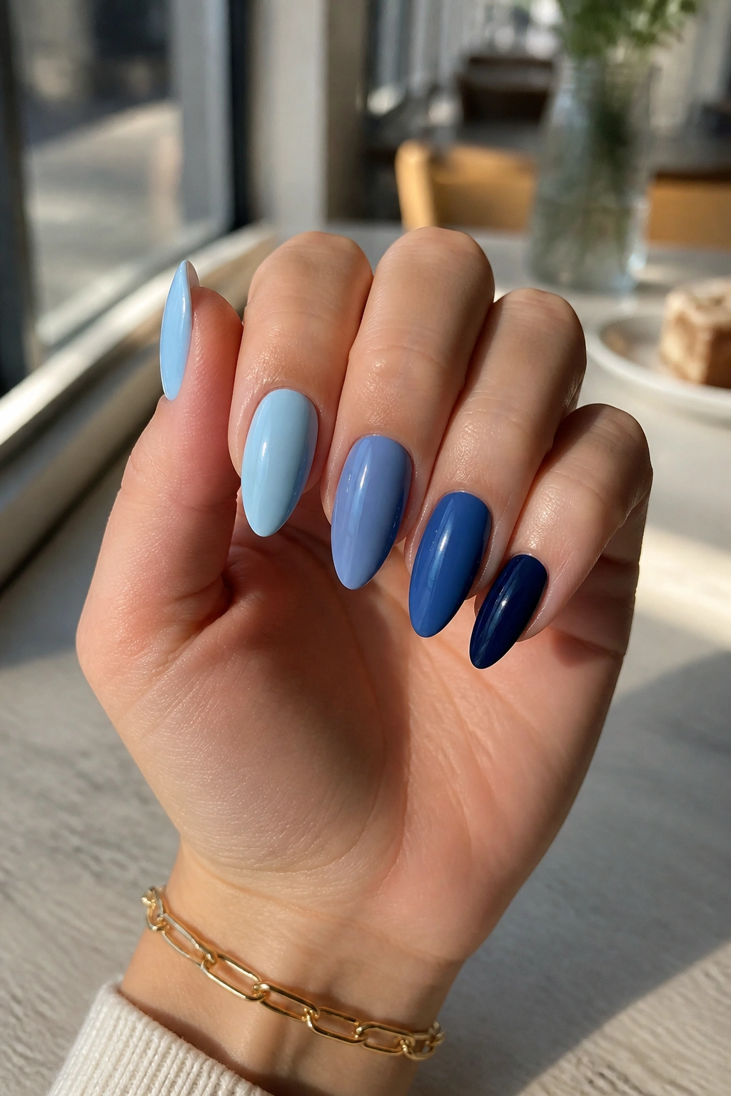 Almond nails with five different blue shades in a skittle set
