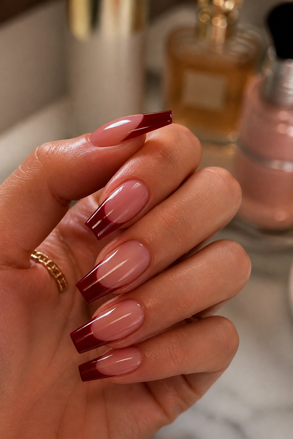 Close-up of a hand with crisp, sharp dark red coffin nails.