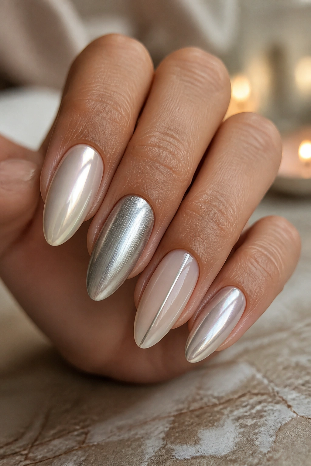 Close-up of almond nails with pearl and silver mixed finishes